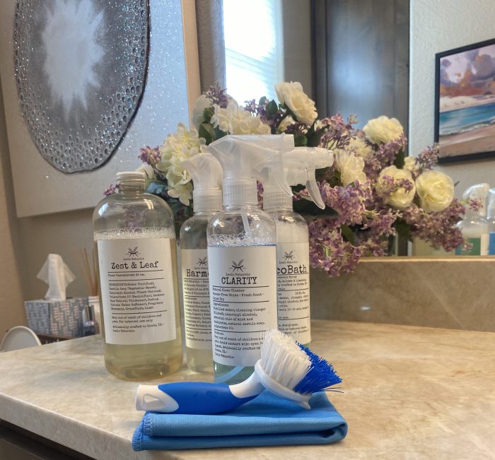 Two Leal&rsquo;s bottles and a microfiber cloth on a bathroom counter