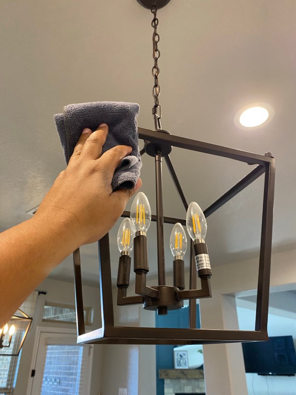 Wiping down a light fixture